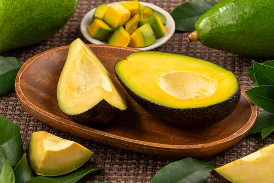 Fresh avocado with sliced and diced pieces over woven bamboo background
