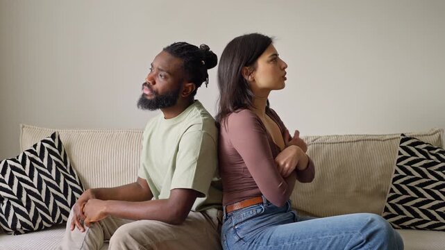Couple ignoring each other sitting on the sofa