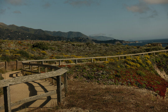 Wooden boardwalk path on a scenic coastal cliff overlooking the ocean