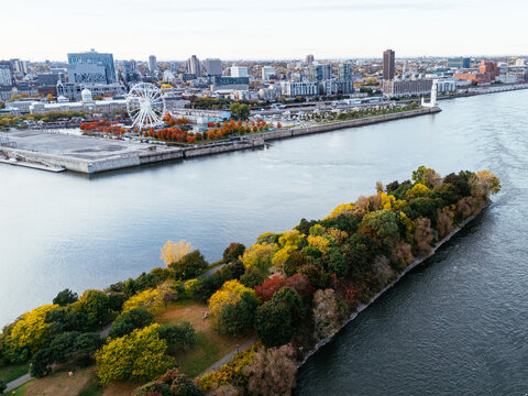 Aerial view of Montreal Old Port with La Grande Roue and Clock tower, autumn foliage, waterfront and downtown skyline
