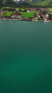 Vertical Aerial Reveal of Achensee Lakeside Village, Houses and Austrian Alpine Mountain Landscape
