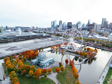 Aerial view of Montreal Old Port with La Grande Roue and Clock tower, autumn foliage, waterfront and downtown skyline