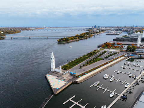 Aerial view of Montreal Old Port with La Grande Roue and Clock tower, autumn foliage, waterfront and downtown skyline