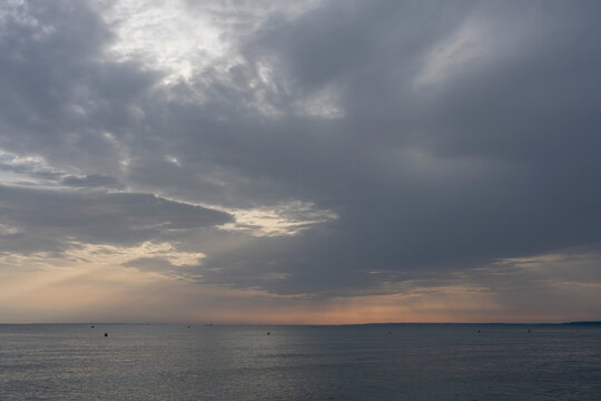 Langrune-Sur-Mer, France - 08 09 2026: Panoramic view of the sea, land and the sky with a ray of light reflecting on the water in the morning