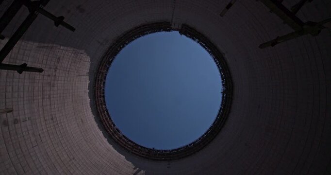 Camera rotates while looking up inside a Chernobyl cooling tower.