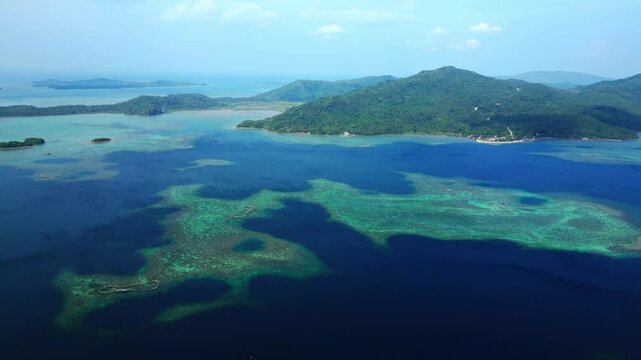 Aerial view from the elevated Cagraray View Deck revealing vivid blue lagoon waters transitioning into deep-blue open sea around Liguan and Cawayan Islands.