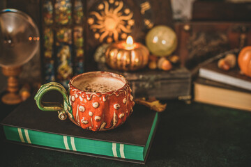 Fototapeta premium Cozy autumn reading scene with open book, warm coffee and subtle magical atmosphere