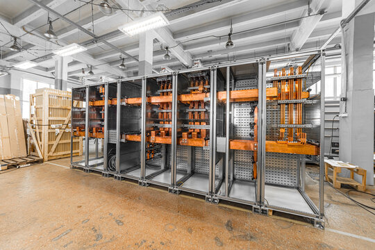 View of industrial electrical switchgear cabinet with copper busbars in a factory setting, Latvia.