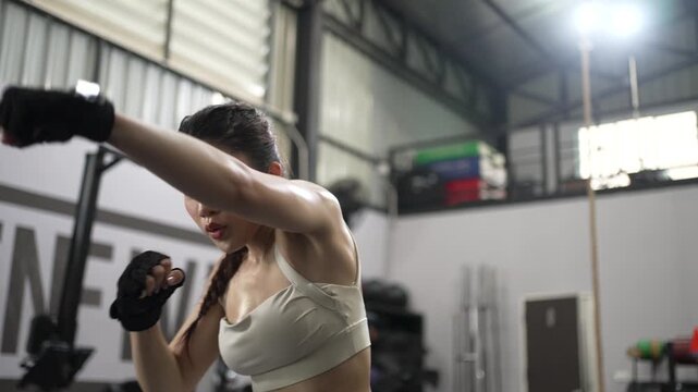 Woman Practices Boxing And Shadow Boxing In Fitness Gym