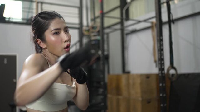 Woman Practices Boxing And Shadow Boxing In Fitness Gym