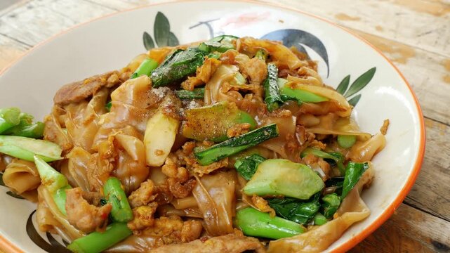 Close-Up of Thai Stir-Fried Wide Rice Noodles with Pork and Kale (Pad See Ew)