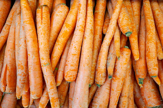 View of fresh orange carrots piled together, showcasing their vibrant color and texture in California City, California, United States.