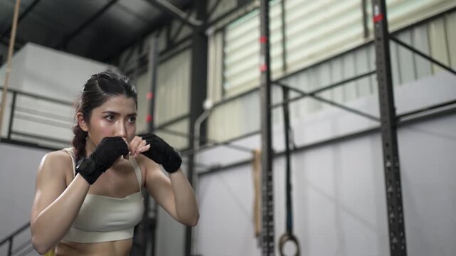 Woman Practices Boxing And Shadow Boxing In Fitness Gym