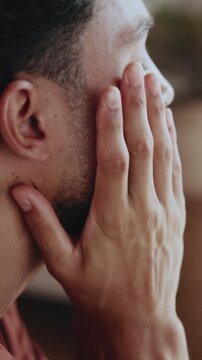 Hands, thinking and man at house with stress, bad decision and emotional distress of past trauma. Overwhelmed, male person and breakdown in lounge with inner conflict, personal crisis and rumination