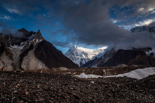 View of the majestic K2 mountain peak rising above the rugged rocky terrain and glaciers of the Karakoram range in Concordia K2 Base, Gilgit Baltistan, Pakistan.