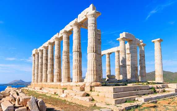 Temple of Poseidon at Cape Sounion against blue sky and sea in Greece
