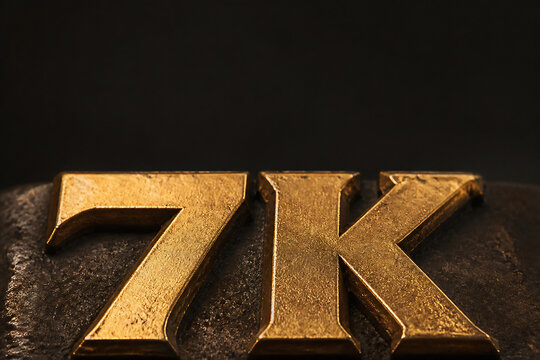 Golden embossed letters "7K" are displayed against a dark, textured background.