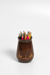A set of pencils in a wooden jar on a white background. Vertical photo. © Richir
