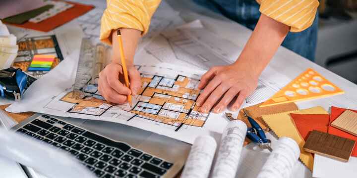 architect Eco retrofit planning with blueprints, material swatches and finish samples, sustainable renovation budget and healthy material selection concept for honest architectural design.