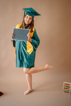 Young girl celebrating educational achievement with graduation attire