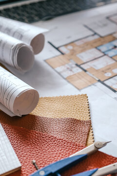 architect Eco retrofit planning with blueprints, material swatches and finish samples, sustainable renovation budget and healthy material selection concept for honest architectural design.