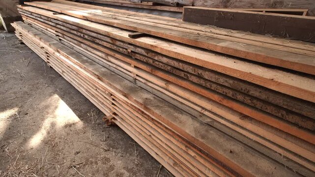 Stacked lumber planks and wooden boards for construction and carpentry projects