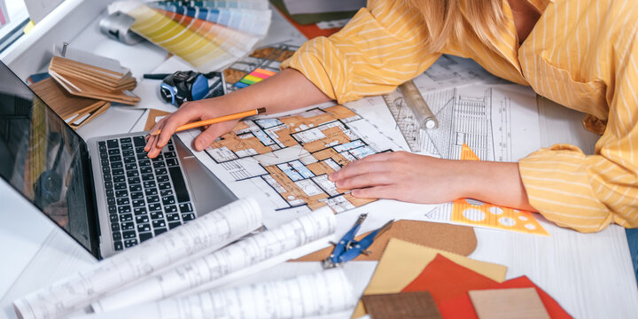 architect Eco retrofit planning with blueprints, material swatches and finish samples, sustainable renovation budget and healthy material selection concept for honest architectural design.