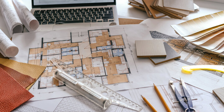 architect Eco retrofit planning with blueprints, material swatches and finish samples, sustainable renovation budget and healthy material selection concept for honest architectural design.