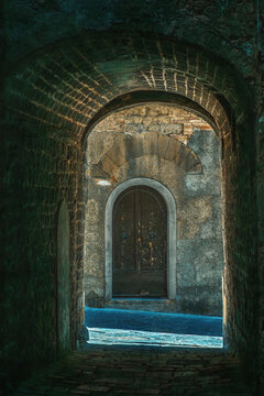 Dark archway in shadow in street of an italian ancient city.