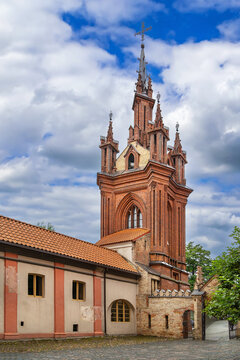 Bell tower of Church of St. Anne in Vilnius, Lithuania, viewed from the courtyard. Cloudy sky over historic brick architecture