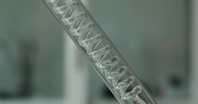 Coiled apparatus consists of glass tube with spiral shape. Transparent walls make movement of vapor and condensed liquid easier to observe