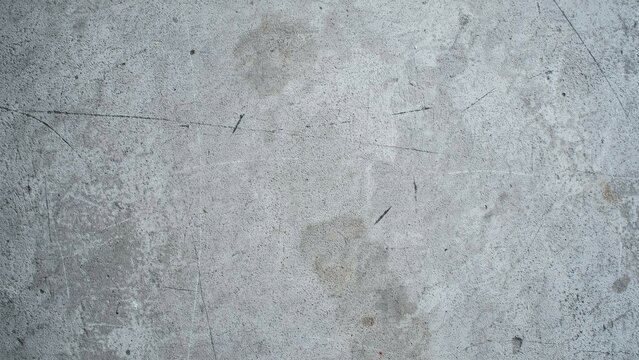 background Industrial concrete texture with weathered grey surface. Grungy cement floor background with scratches and stains. Distressed stone wall material for architectural design and 3D