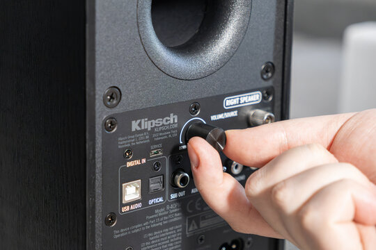 Poznan, Poland - January 4, 2026: Klipsch monitor speaker volume control adjustment by a finger as the user manually tunes sound output levels for a high fidelity home audio setup
