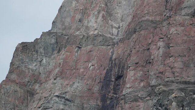 Small Rockfall from Steep Uummannaq Mountain Cliff in Greenland