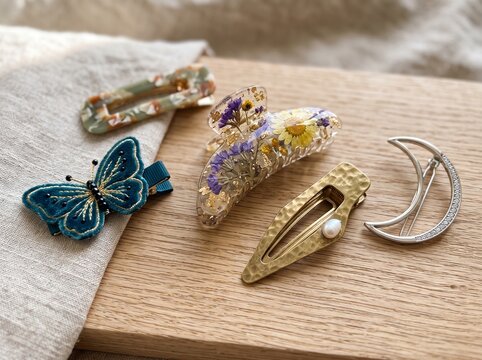 Aesthetic handmade hair clips collection with butterfly resin floral and moon barrette on wooden table