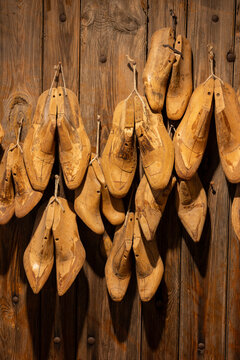 Wooden shoe lasts hanging on the wall of an artisan cobbler workshop