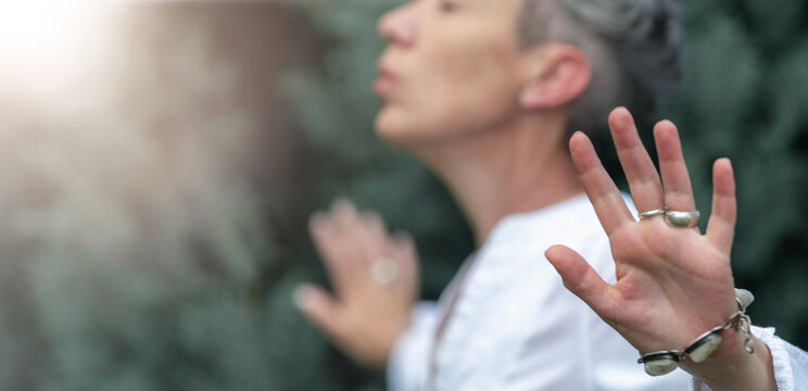 Mindfulness practice with open hands projecting healing light and spiritual energy, wellness meditation