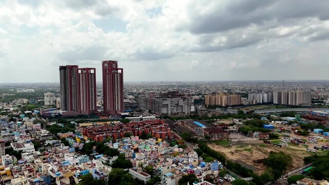 Aerial drone footage of SPR City and surrounding Perambur neighborhoods, capturing multiple tall residential towers, ongoing construction, clusters of apartment buildings, dense housing, and extensive