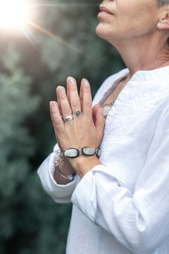 Heart-centered mindfulness practice with hands in prayer position, spiritual healing meditation,   outdoors