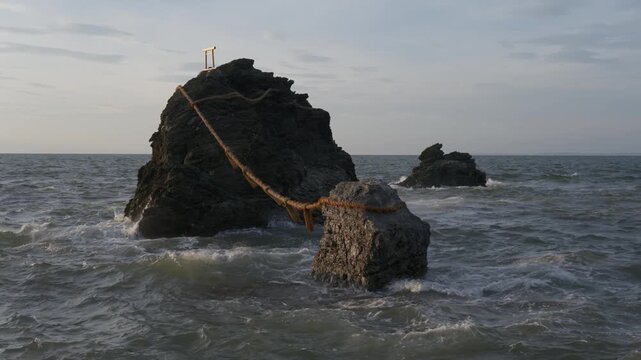 Meoto Iwa Wedded Rocks at Futami Okitama Shrine in Ise City during Sunset with Roaring Sea Waves, Japan