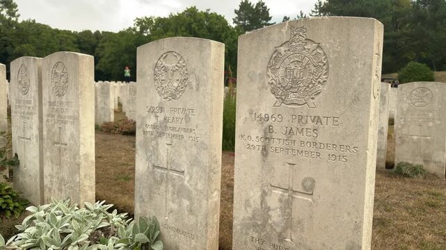 Rows of World War I military headstones in a peaceful cemetery with greenery