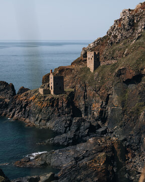 View of the historic Botallack Mine and Engine House perched on the rugged cliffs overlooking the Atlantic Ocean in Saint Just, England, United Kingdom.
