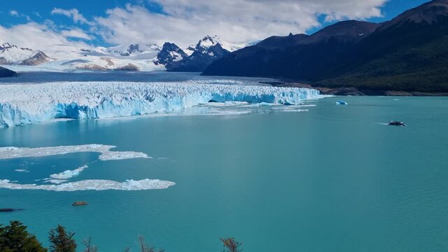 Panoramic view of Perito Moreno Glacier in Patagonia, Argentina, with massive blue white ice formations meeting the turquoise waters of Lago Argentino amid a vast rugged wilderness