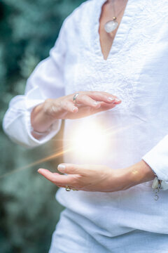 Mindfulness practice with hands surrounding a glowing energy field, spiritual wellness meditation