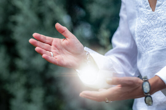 Mindfulness practice projecting healing light from open hands, spiritual wellness meditation