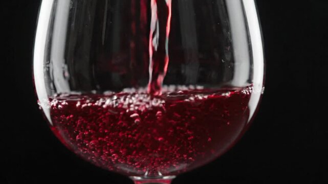 Pouring red wine into a glass in super slow motion with VSRExport software
