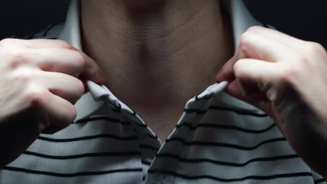 The collar of a guy's white striped shirt.
A person adjusts the collar.