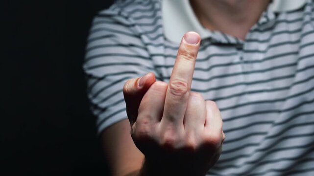 Close-up of a middle finger.
"Fuck you" gesture.