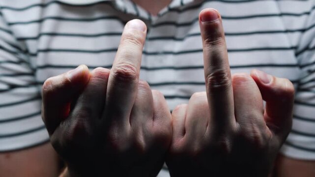 Close-up of a middle finger.
"Fuck you" gesture.