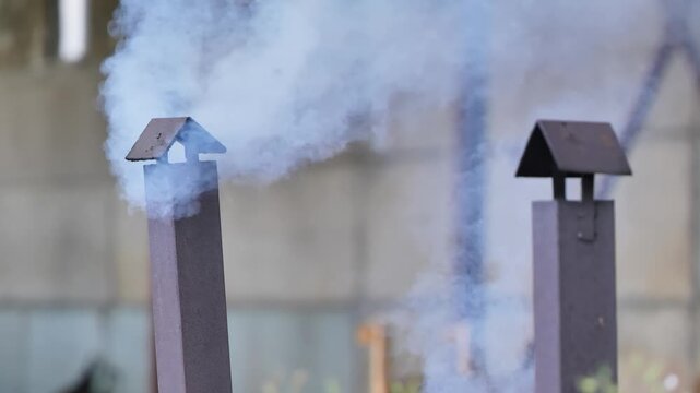 Farm chimney emitting smoke into the air, representing industrial agriculture exhaust